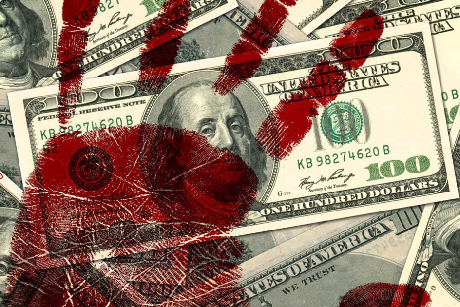 A heap of 100 dollar bills with a red imprint of a hand on them