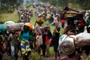 People migrating with their belongings escaping crisis in DRC