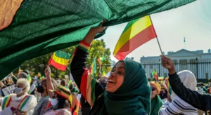 A group of Ethiopian women waving Ethiopian flags in a gathering