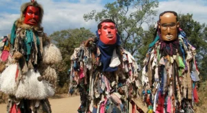 Three traditional costume dressers from Malawi in The Great Lakes Region pose for a photo