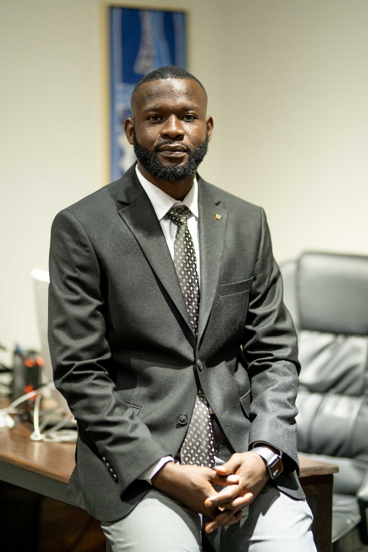 A sharply dressed Mr. Nsiku Jeremie in an office setting