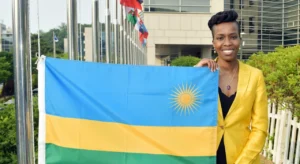 A young lady holding the Rwandan flag as it is being hosted when Rwanda joined IVI